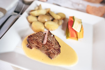 Grilled steak with seasonal vegetables and sauce