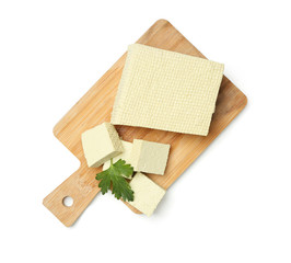 Cutting board with tasty tofu cheese on white background