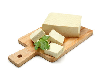 Cutting board with tasty tofu cheese on white background