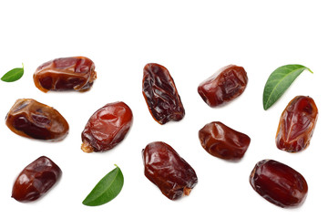 date fruits with green leaves isolated on white background. top view