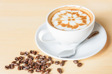 hot cappuccino coffee with nice pattern foam on table