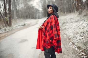 Elegant black girl in a winter park