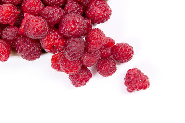 Harvested juicy ripe raspberries fruit on white background..