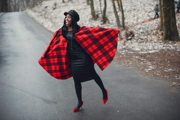 Elegant black girl in a winter park