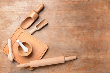 Set of wooden kitchen utensils on table