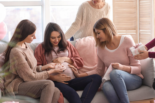 Pregnant Woman With Her Friends At Baby Shower Party