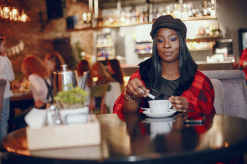 Elegant black girl in a cafe