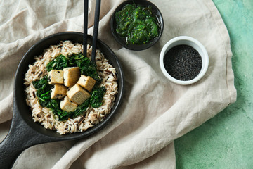 Tasty rice with tofu cheese in bowl on table
