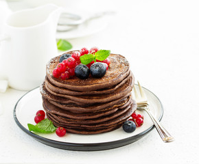 Chocolate pancakes with berries.