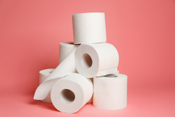 Rolls of toilet paper on color background