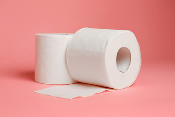 Rolls of toilet paper on color background