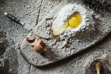 Preparation of the dough on a wooden background