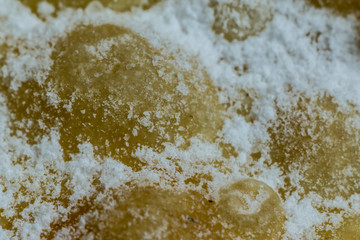 Macrophoto. European dessert angel wings. Interesting tech tour deep fried dough strips with powdered sugar. Site about the kitchen, pastries, sweets.