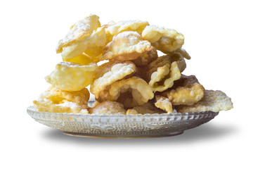 Angel wings are pastry made of dough, thin twisted ribbons, deep fried and sprinkled with powdered sugar .Europe .Isolated photo on white background.