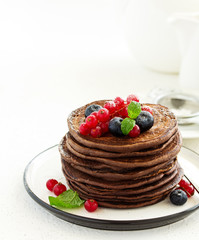 Chocolate pancakes with berries.