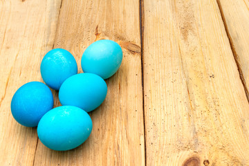 Easter concept with colorful eggs on wooden background, close up, copy space