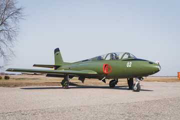 Big old green jet plane parked on the runway