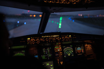 Pilot's hand accelerating on the throttle in  a commercial airliner airplane flight cockpit during takeoff