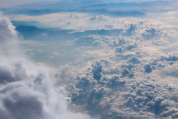 Panorama from window of plane with white clouds