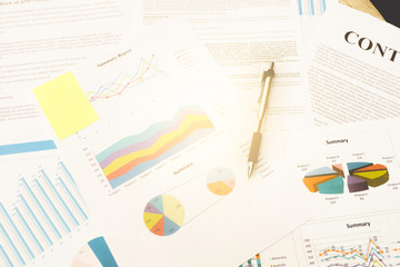 Office desk table with Analysis data and Pen.