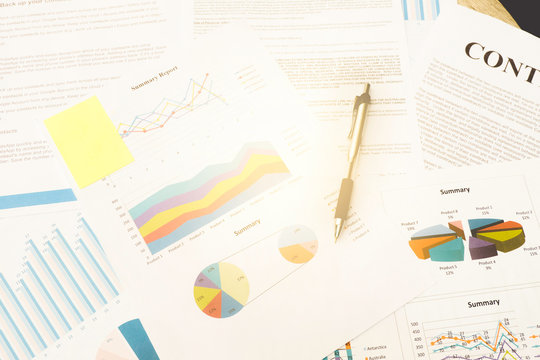 Office desk table with Analysis data and Pen.