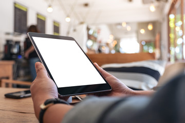 Mockup image of woman's hands holding black tablet pc with blank screen in cafe