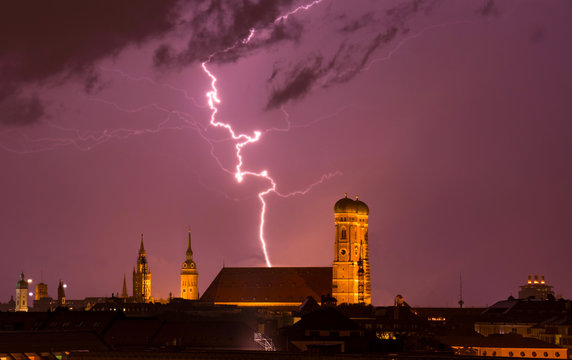 lightning strikes into munich cathedral Frauenkirche while thunderstorm. travel bavaria germany skyline M&uuml;nchen