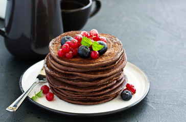 Chocolate pancakes with berries.