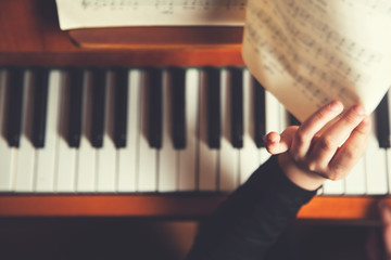 Fototapeta na wymiar girl hand music book with piano
