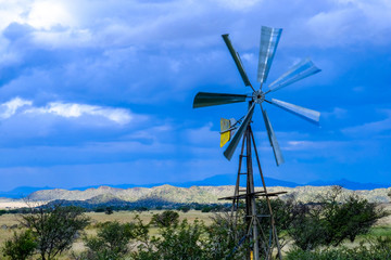 Stunning photo of a windmill with some stormy clouds in the background