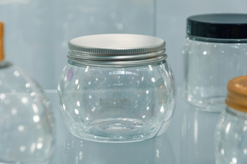 Round glass jar with a closed metal lid.