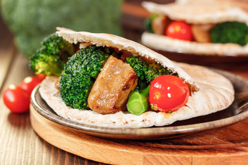 Meat with vegetables in a pita bread.