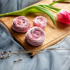 pink marshmallow on Board with flowers