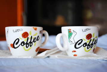 Two Cups of coffee on a white table. On a dark blurred background. Espresso..