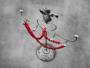 Fototapeta na wymiar Red necklace on a metal stand interior accessory