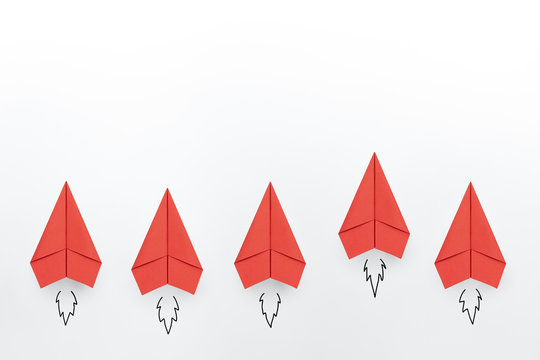 Red paper planes on white background. Business competition concept.