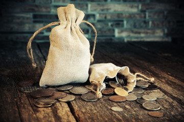 Pouch with old money and coins. Vintage style.Treasure searching concept.Gold,silver.Numismatics and collecting money
