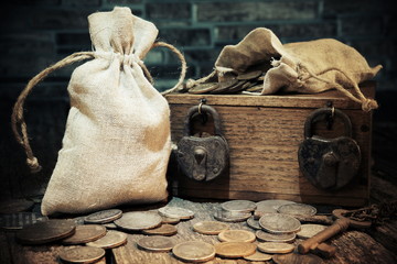 Pouch with old money and coins.Treasure chest.Padlocks and keys.Travel and marine engraving background.Vintage style.Treasure searching concept.Gold,silver.Numismatics 