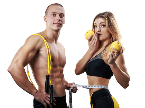 Athletic couple isolated. Muscular Man and Woman with measuring tape in gym. Weight loss, bodybuilding, sport and fitness, coach, workout, dieting and health. - Image
