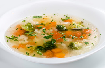 Vegetable soup with broccoli on white background