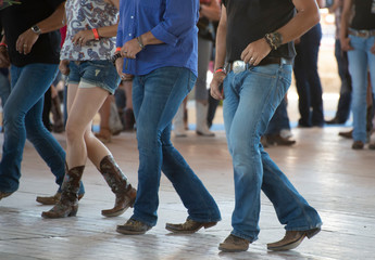 Men and woman line dance in country club - obrazy, fototapety, plakaty