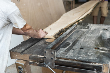 Design wood small business concept. Cropped back rear photo of cabinetmaker or handyman saw wood plank board make furniture in garage or workroom