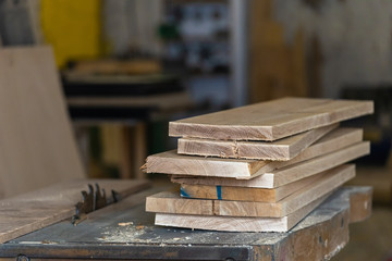 Hobby wood concept. Close up photo of wooden plank board on saw table in empty garage or workroom...