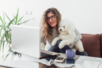 Young woman working at home. She is with her dogs