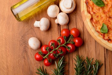 Cooking ingredients near pizza 