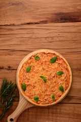 Rosemary near board with pizza