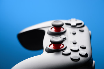 Game pad. Modern video game controller. Joy stick on blue background with copy-space.