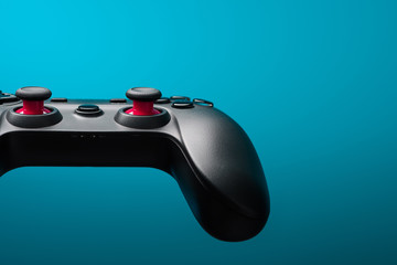 Game controller joy stick. Video game pad retro toned on blue background with copy space.