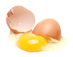 Cracked egg, eggshell with yolk isolated on white background