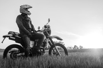 Fototapeta na wymiar Motorcyclist on green grass off road, enduro, extreme sport, active lifestyle, adventure touring concept, enduro outdoor